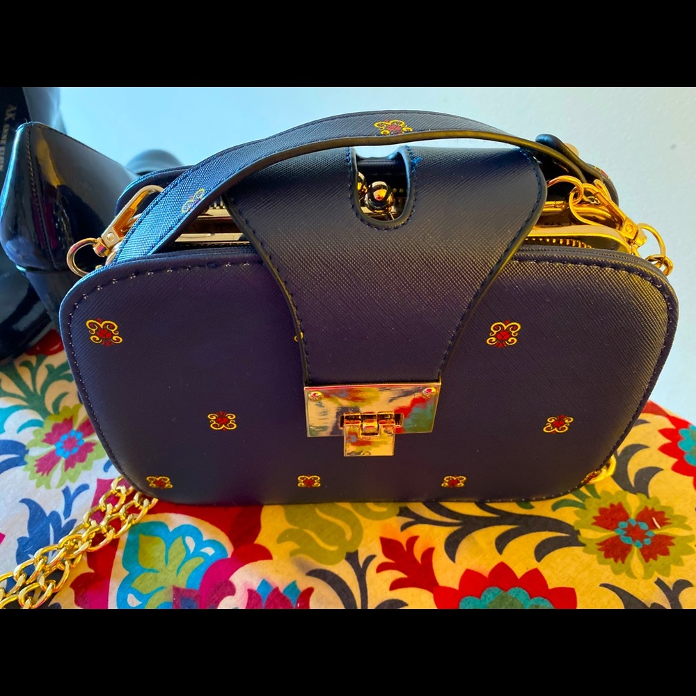 Navy imprint of ladybug, chained 3 pocket purse